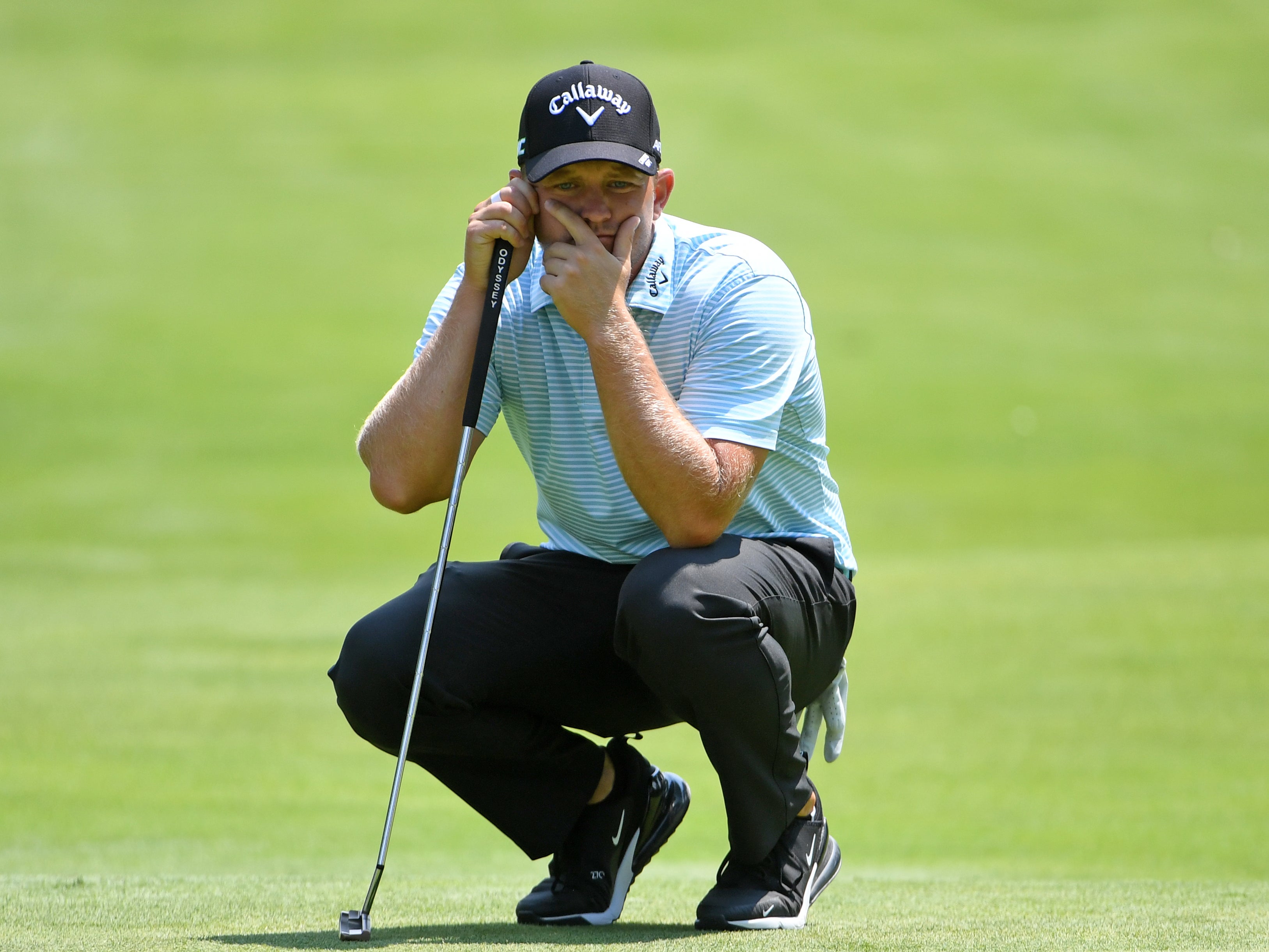 Tom Lewis lines up a putt on the PGA Tour