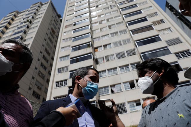 <p>Opposition leader Juan Guaido speaks to the press at his residential building in Caracas, Venezuela, Monday, July 12, 2021. Guaido said security forces threatened his driver when he and his driver arrived home Monday.</p>