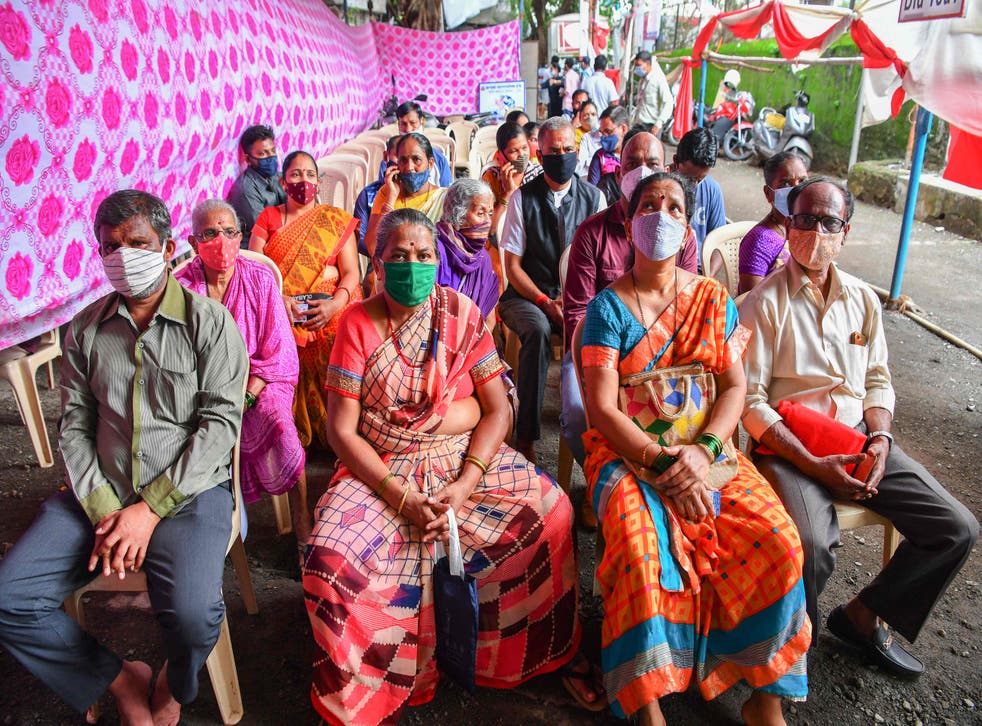 <p>People wait for the arrival of Covid-19 vaccine doses at a centre in India’s Mumbai city on 12 July, 2021</p>