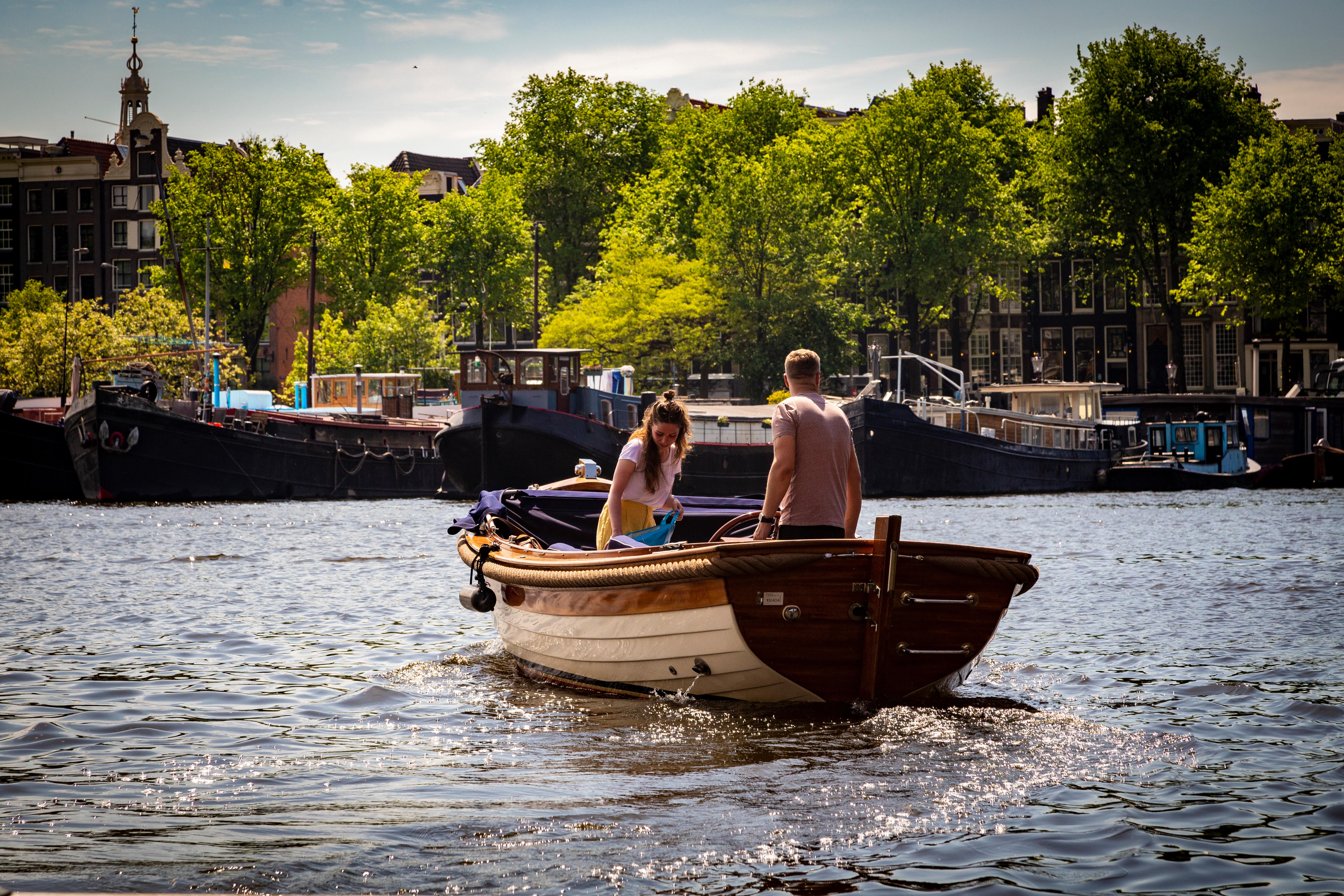 Couple riding a boat in Amsterdam