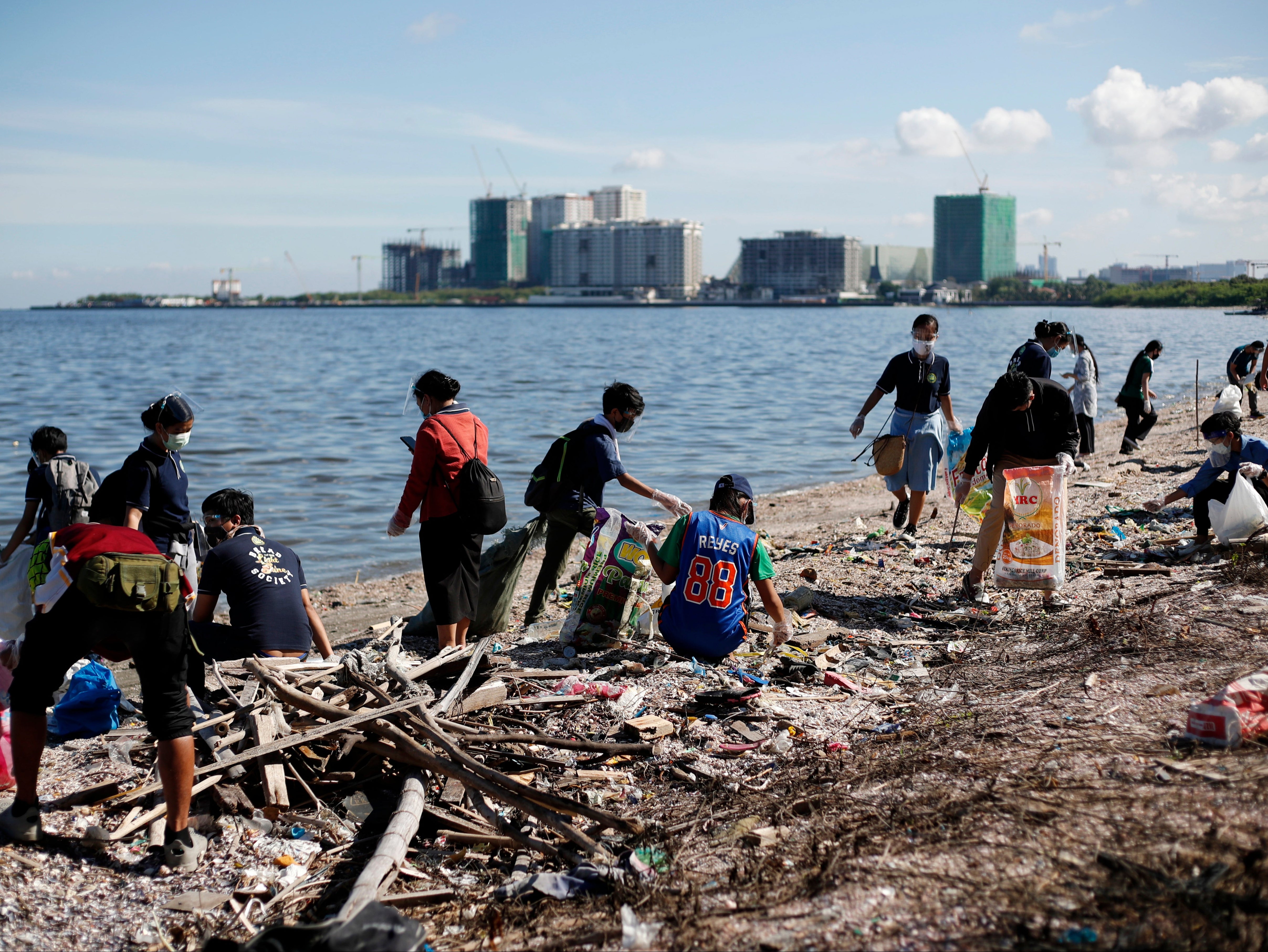 Volunteers cleaning a beach in Manila Bay, Philippines