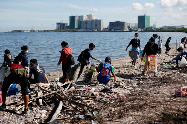 <p>Volunteers cleaning a beach in Manila Bay, Philippines</p>