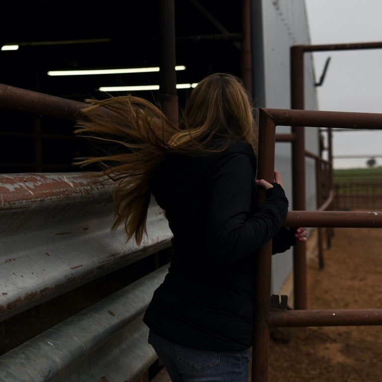 Munson opens a gate at her family’s ranch