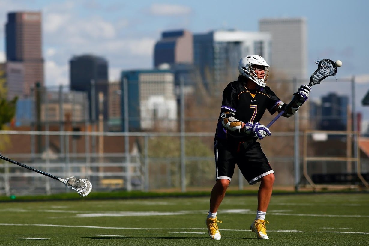 Wolf practices lacrosse at North High School in Denver