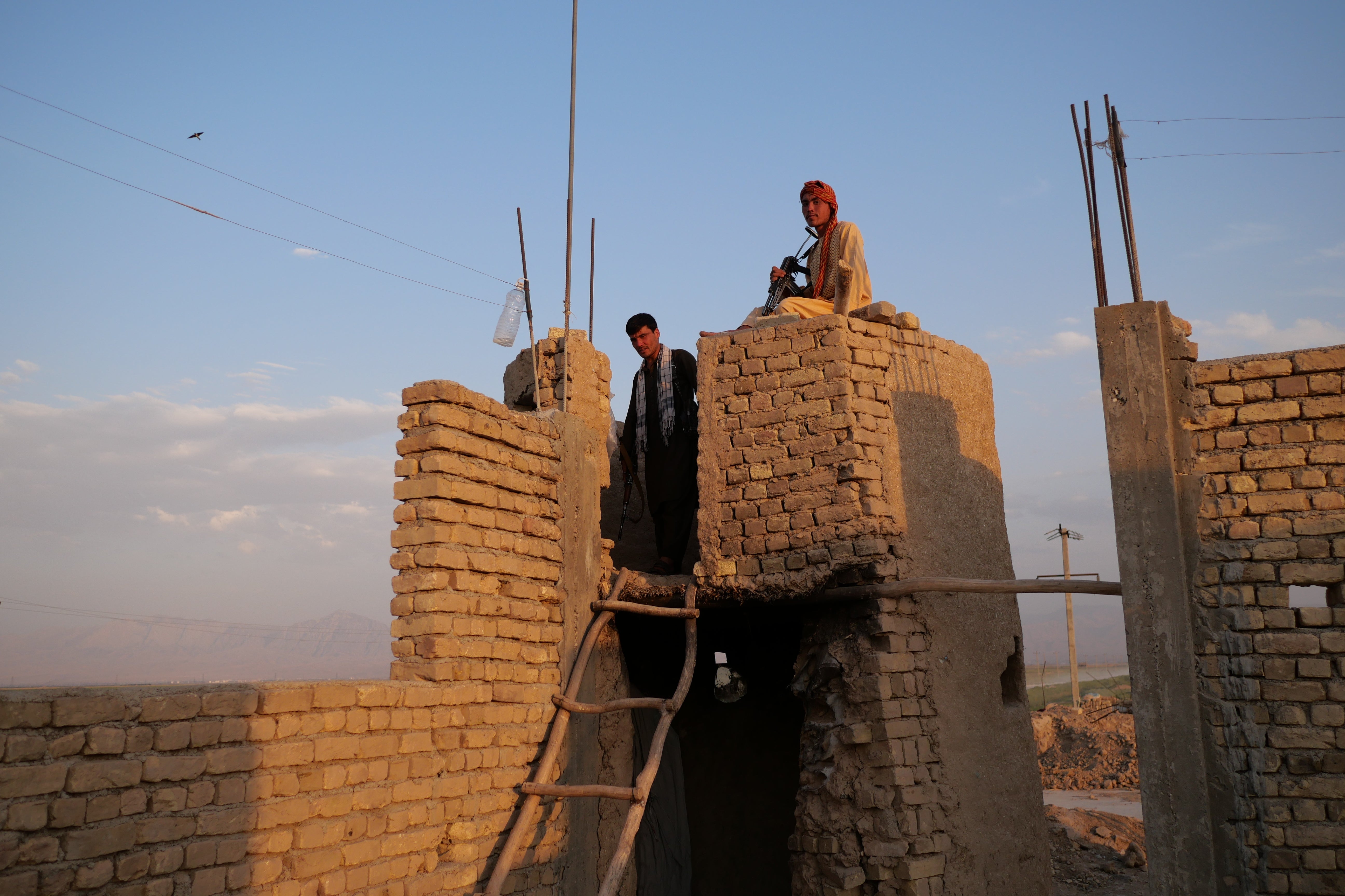 Militia fighters keep watch on a frontline in Siahgerd to the north of Mazar-i-Sharif, Balkh province, where Taliban fighters threatened to breach the city’s defences in recent days