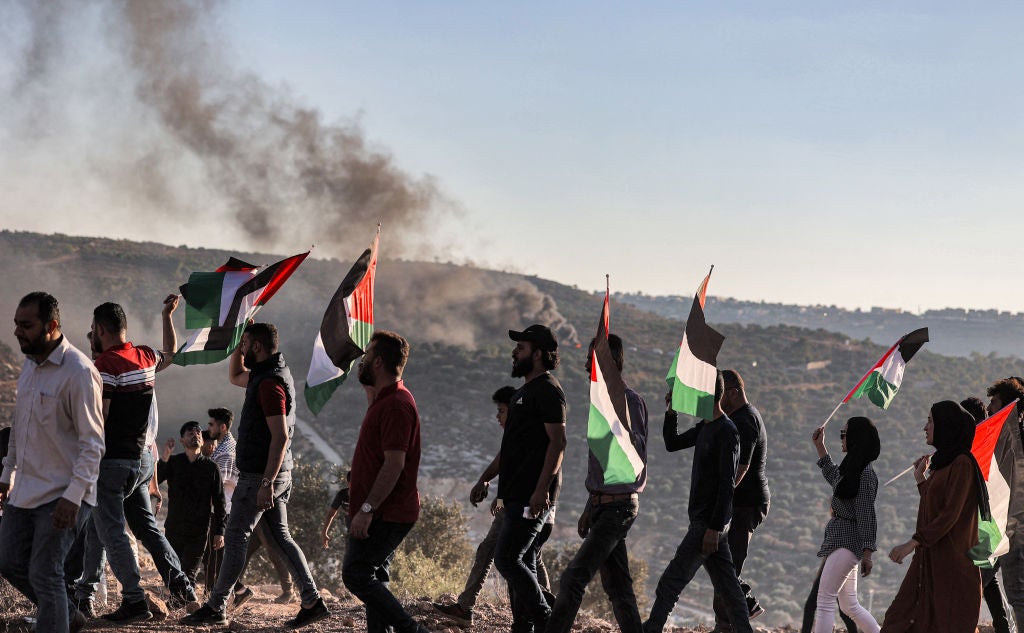 <p>Palestinian protesters gather during a demonstration against the Israeli outpost of Eviatar, in the town of Beita, near the occupied West Bank city of Nablus, on 6 July</p>