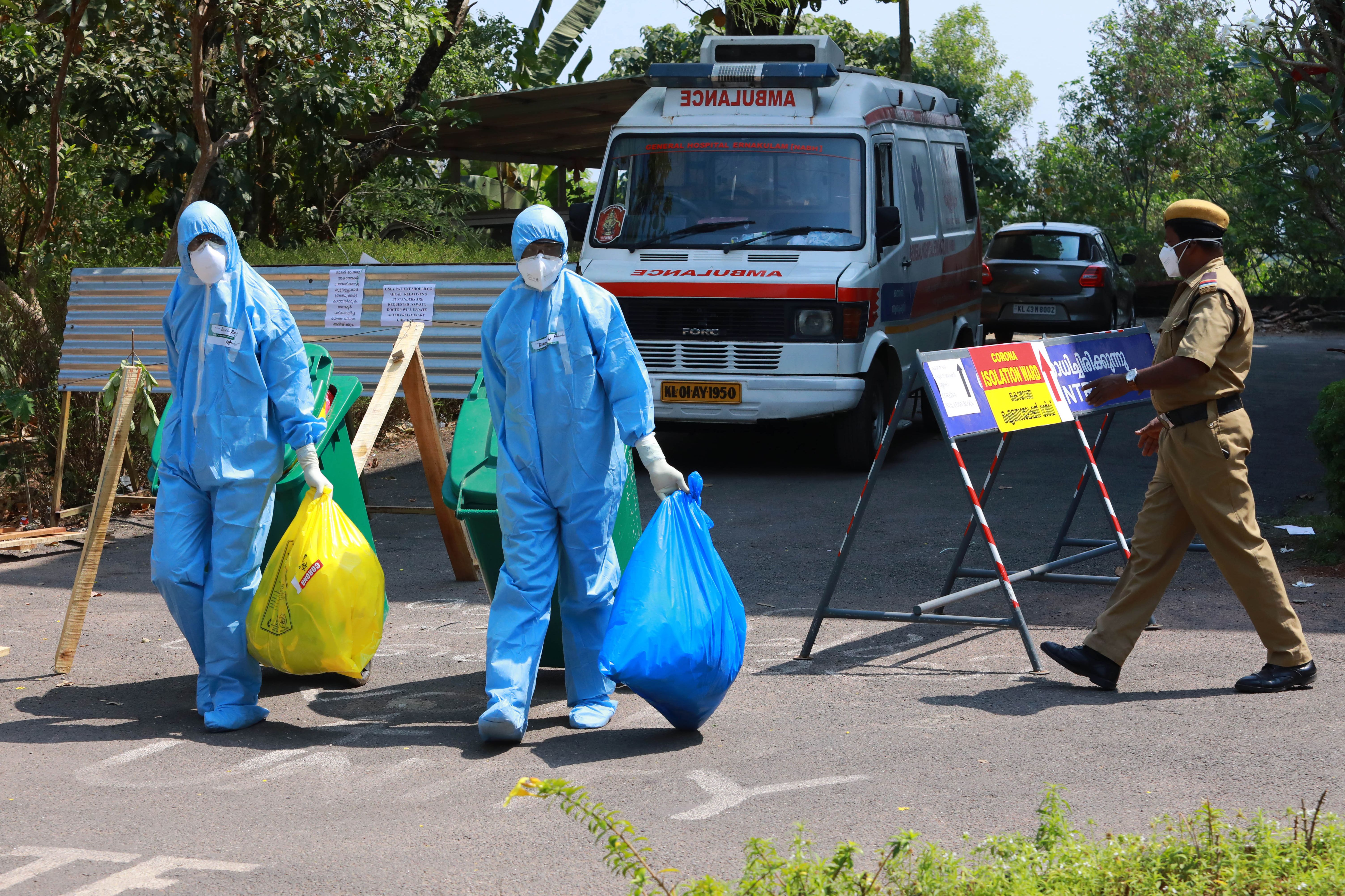 File: Heath officials carry medical waste out of an isolation ward of a hospital in Kochi, Kerala on 4 February, 2020