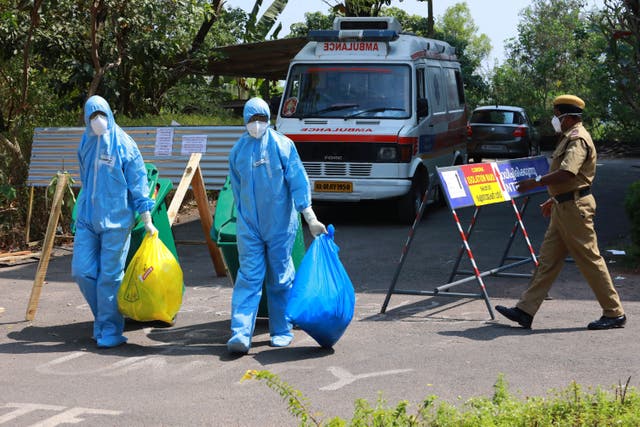 <p>File: Heath officials carry medical waste out of an isolation ward of a hospital in Kochi, Kerala on 4 February, 2020</p>