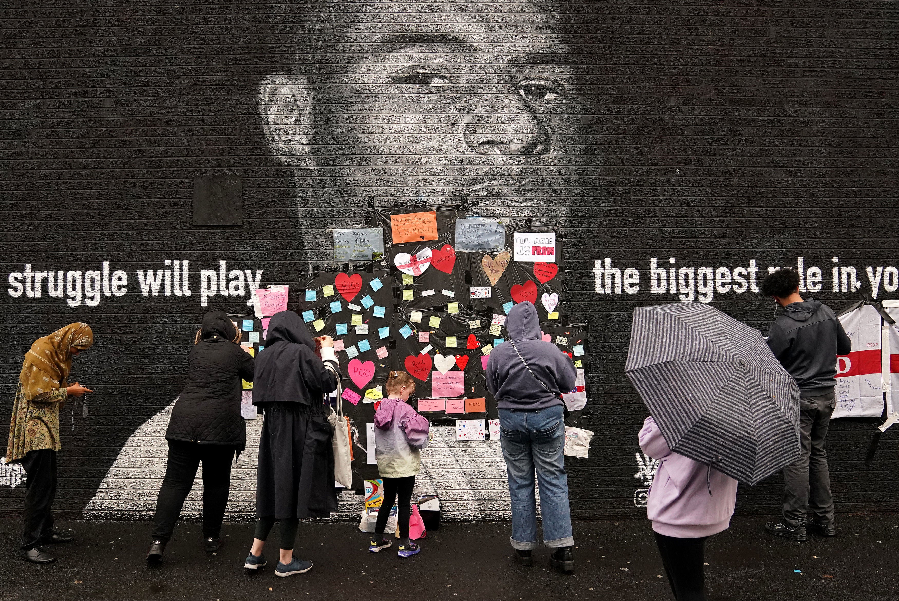 Hundreds descend on defaced Marcus Rashford mural to decry racist