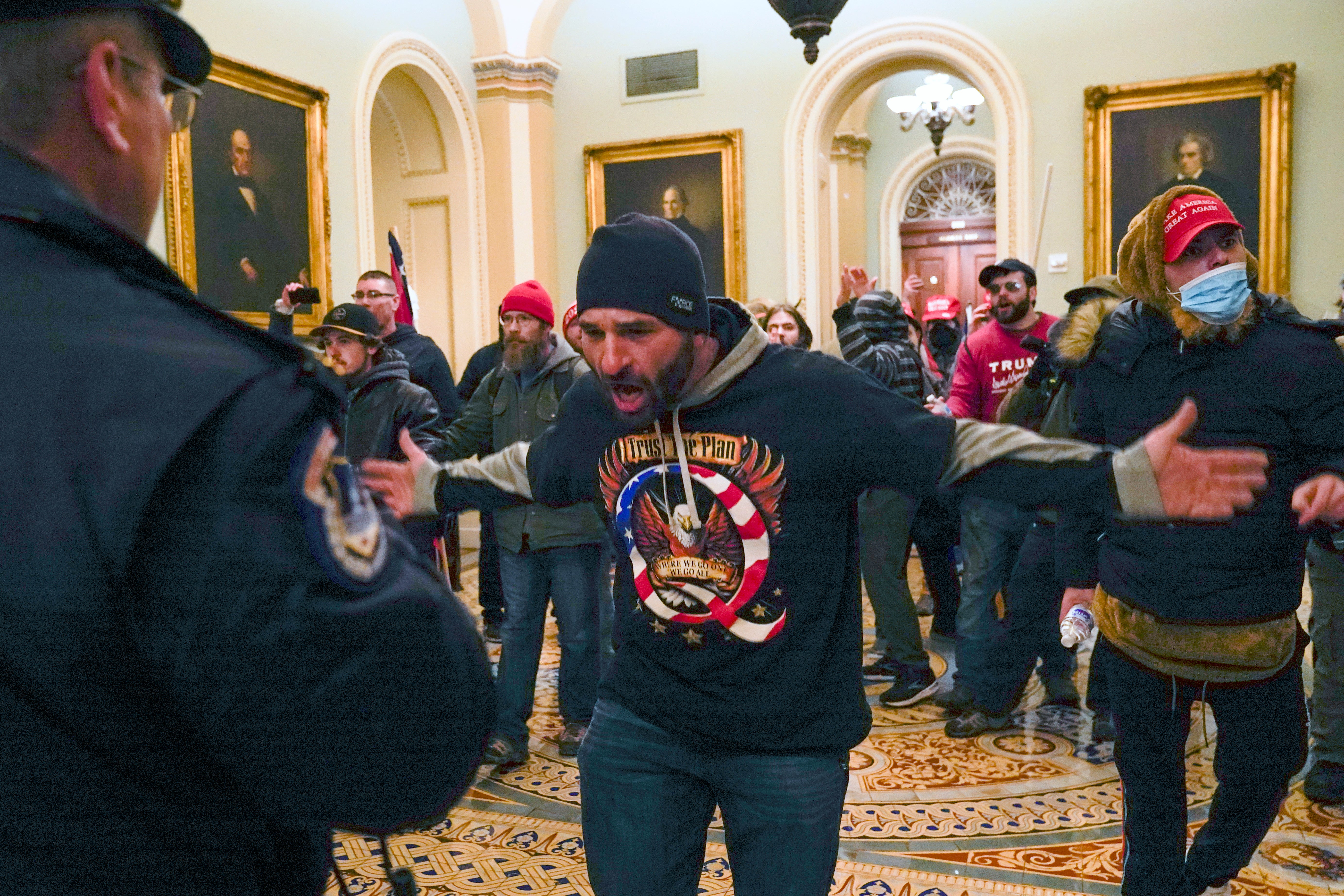 File: Trump supporters, including Doug Jensen, centre, confront US Capitol police in the hallway outside of the Senate chamber at the Capitol