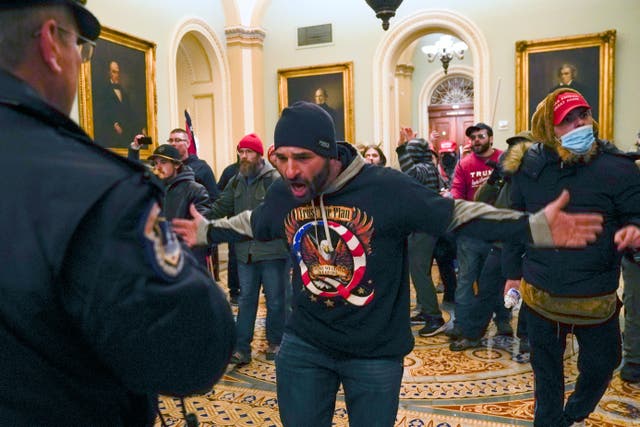 <p>File: Trump supporters, including Doug Jensen, centre, confront US Capitol police in the hallway outside of the Senate chamber at the Capitol </p>