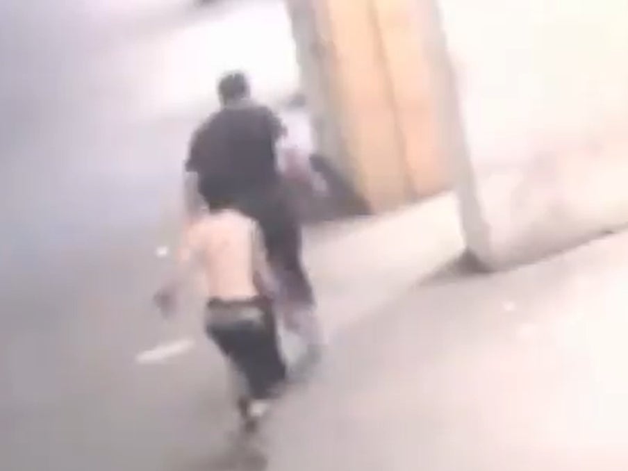 In the footage, a man can be seen running up to the 57-year-old victim before throwing an unknown substance on his back