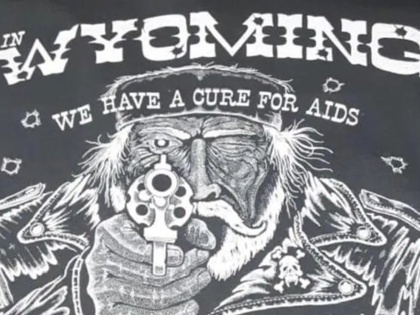 A shirt sold in a bar in Wyoming that depicts a man with a revolver and a line of text celebrating the shooting of LGBT+ people