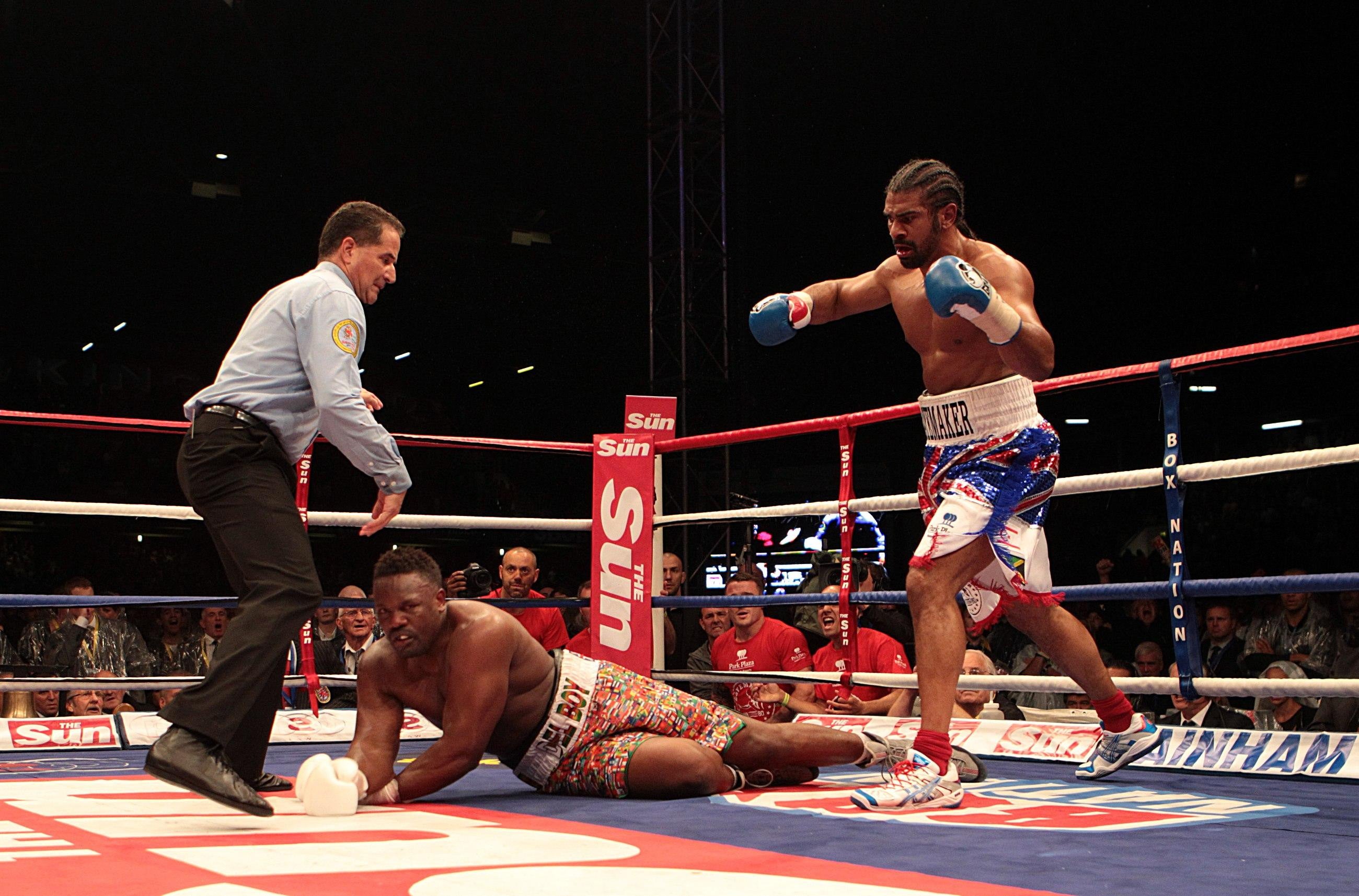 David Haye (right) knocks down Dereck Chisora in the fifth round of their heavyweight bout at Upton Park in 2012