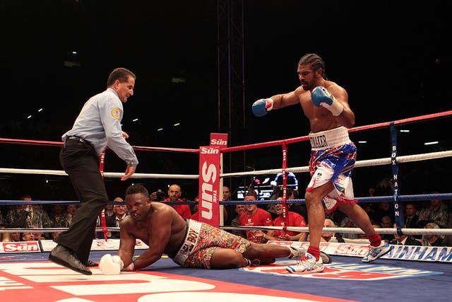 <p>David Haye (right) knocks down Dereck Chisora in the fifth round of their heavyweight bout at Upton Park in 2012</p>
