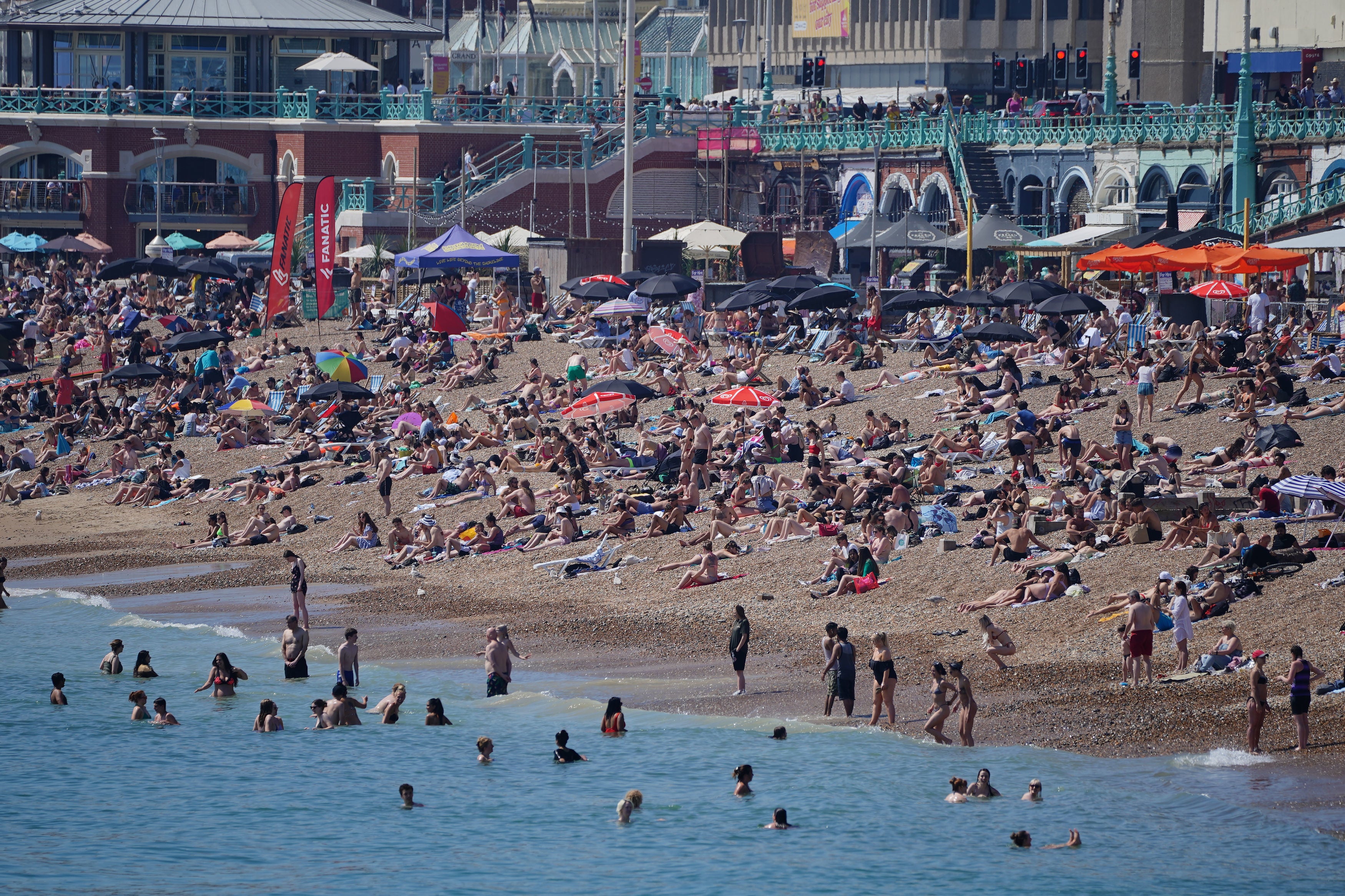 Crowds of people enjoying the sunshine on Brighton beach