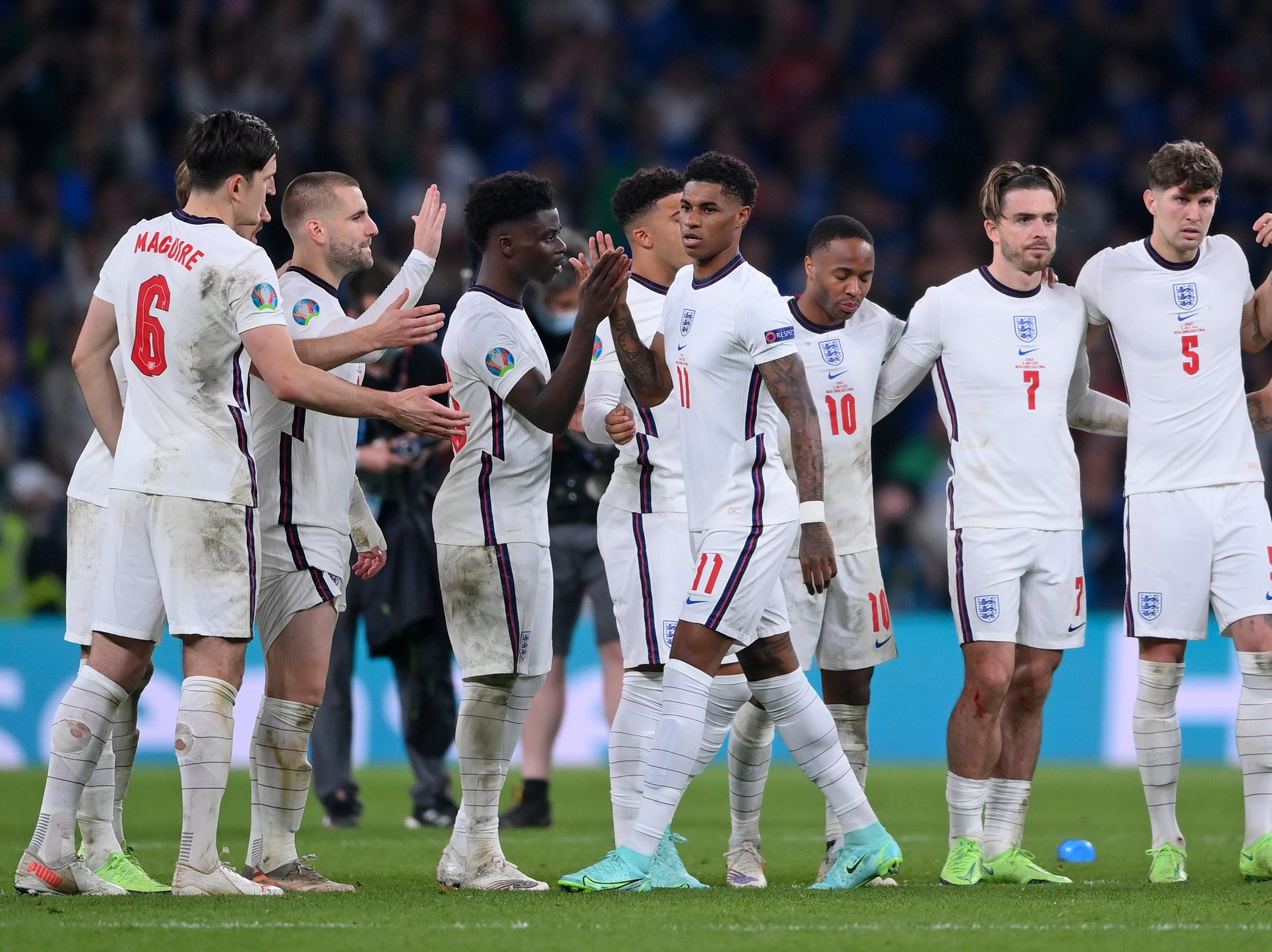 England’s Harry Maguire, Luke Shaw and Bukayo Saka reach out to Marcus Rashford after he missed a penalty in the penalty shootout of the Euro 2020 final