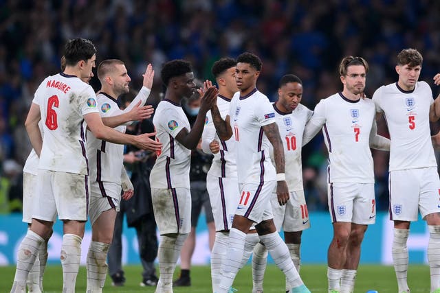 <p>England’s Harry Maguire, Luke Shaw and Bukayo Saka reach out to Marcus Rashford after he missed a penalty in the penalty shootout of the Euro 2020 final</p>