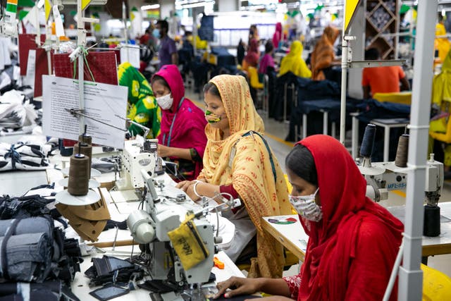 <p>Garment workers at a factory in Dhaka, Bangladesh during the Covid-19 pandemic</p>