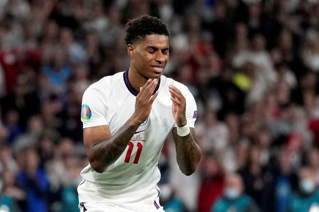 <p>Marcus Rashford looks dejected after missing his penalty in Sunday night’s final</p>