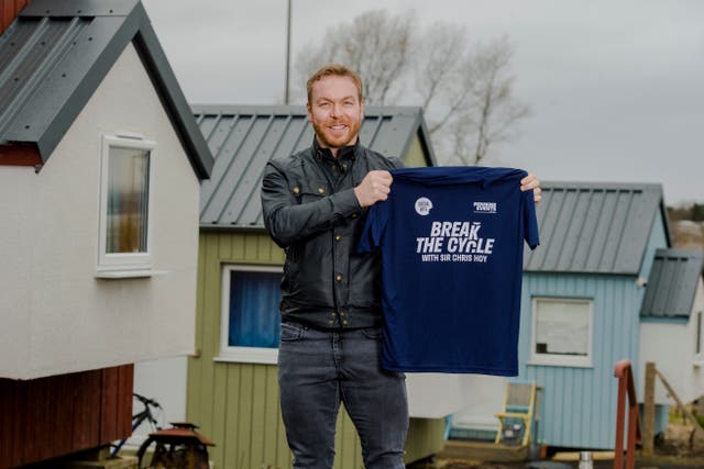 <p>Sir Chris Hoy holds up a Break the Cycle T-shirt</p>