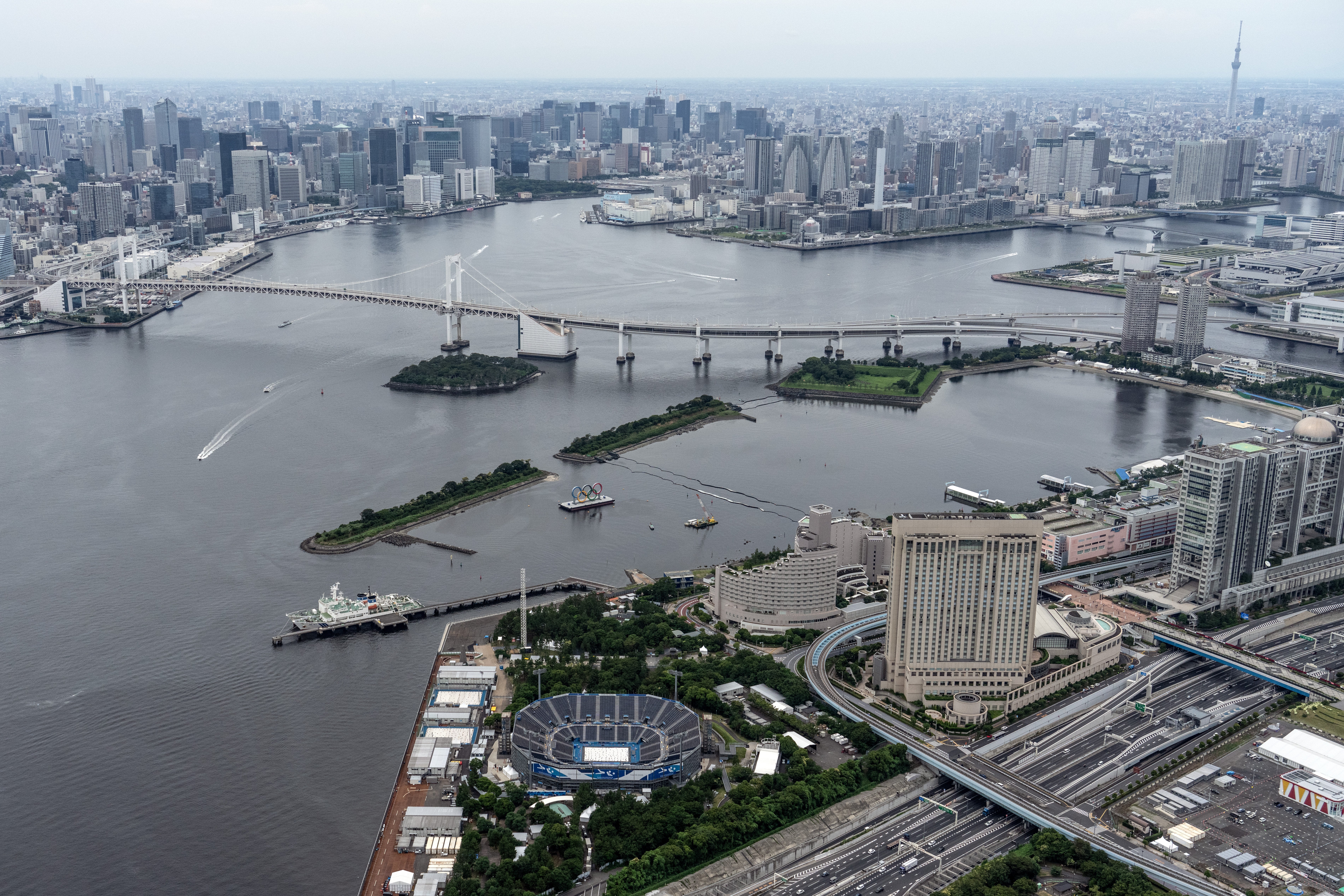 Tokyo Bay, Odaiba Marine Park and the Tokyo Olympic beach volleyball stadium are pictured from a helicopter on 26 June 2021 in Tokyo, Japan