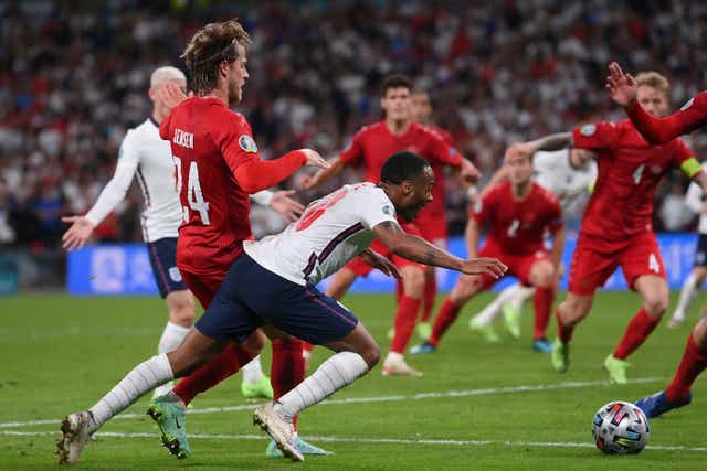 Raheem Sterling goes down after a challenge in the box, winning England a penalty in the Euro 2020 semi-final against Denmark