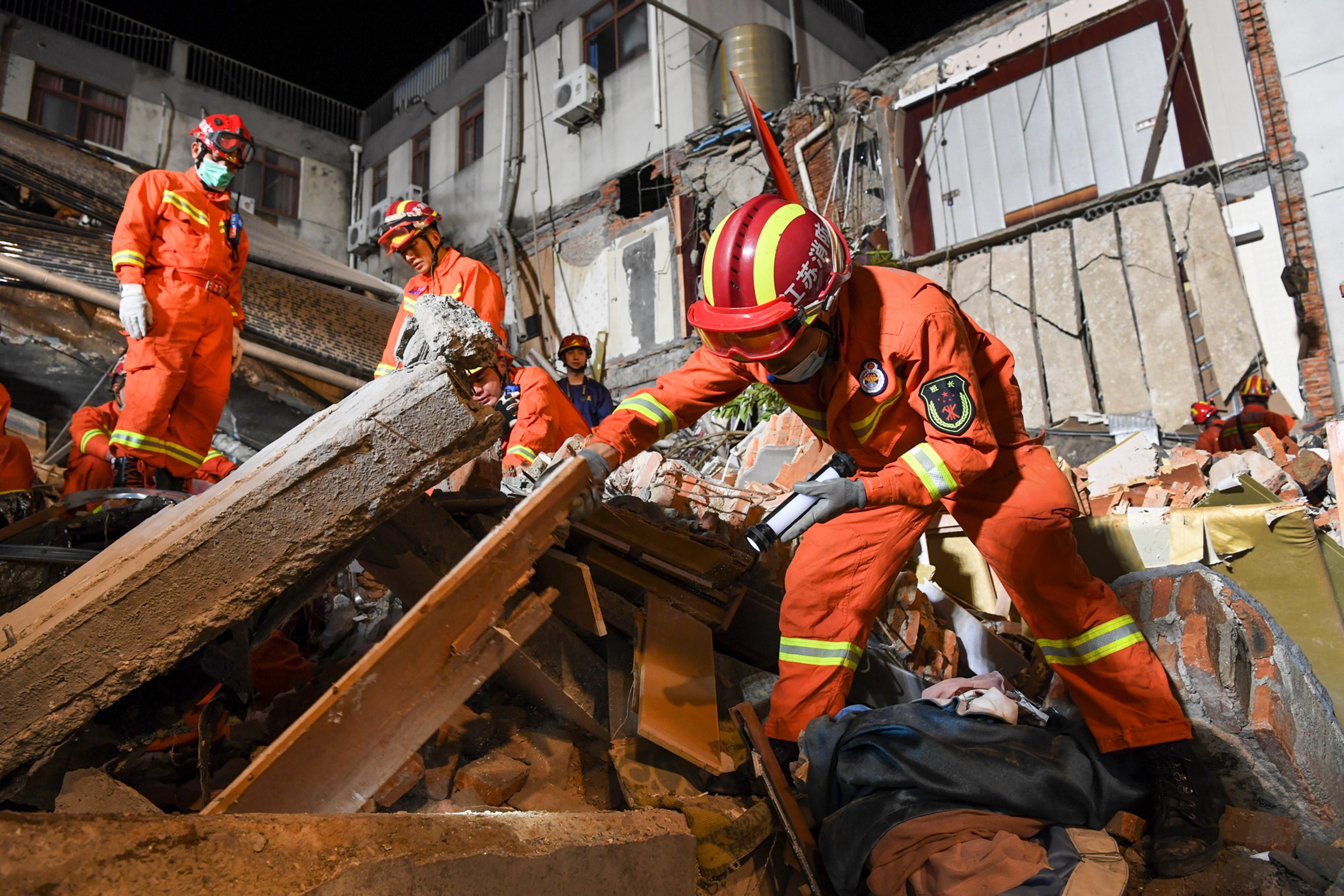Rescuers search for survivors at a collapsed hotel in Suzhou in eastern China’s Jiangsu Province on 12 July 2021