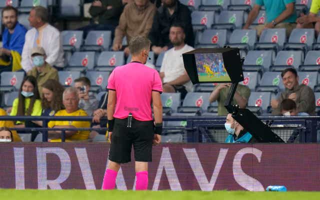 <p>Referee Daniele Orsato carries out an on-field review before dismissing Marcus Danielson of Sweden</p>