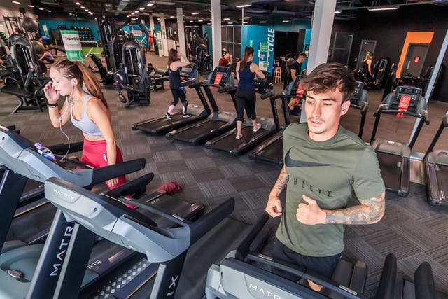 People using exercise machines at a PureGym site