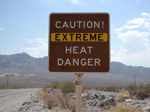 <p>A sign warns of extreme heat in Death Valley, California, US 11 July 2021</p>