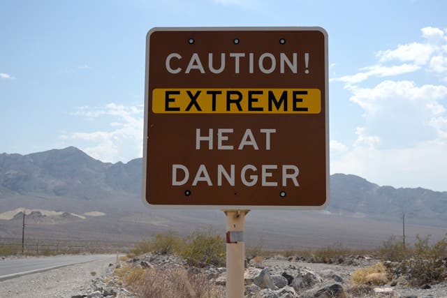 <p>A sign warns of extreme heat in Death Valley, California, US 11 July 2021</p>