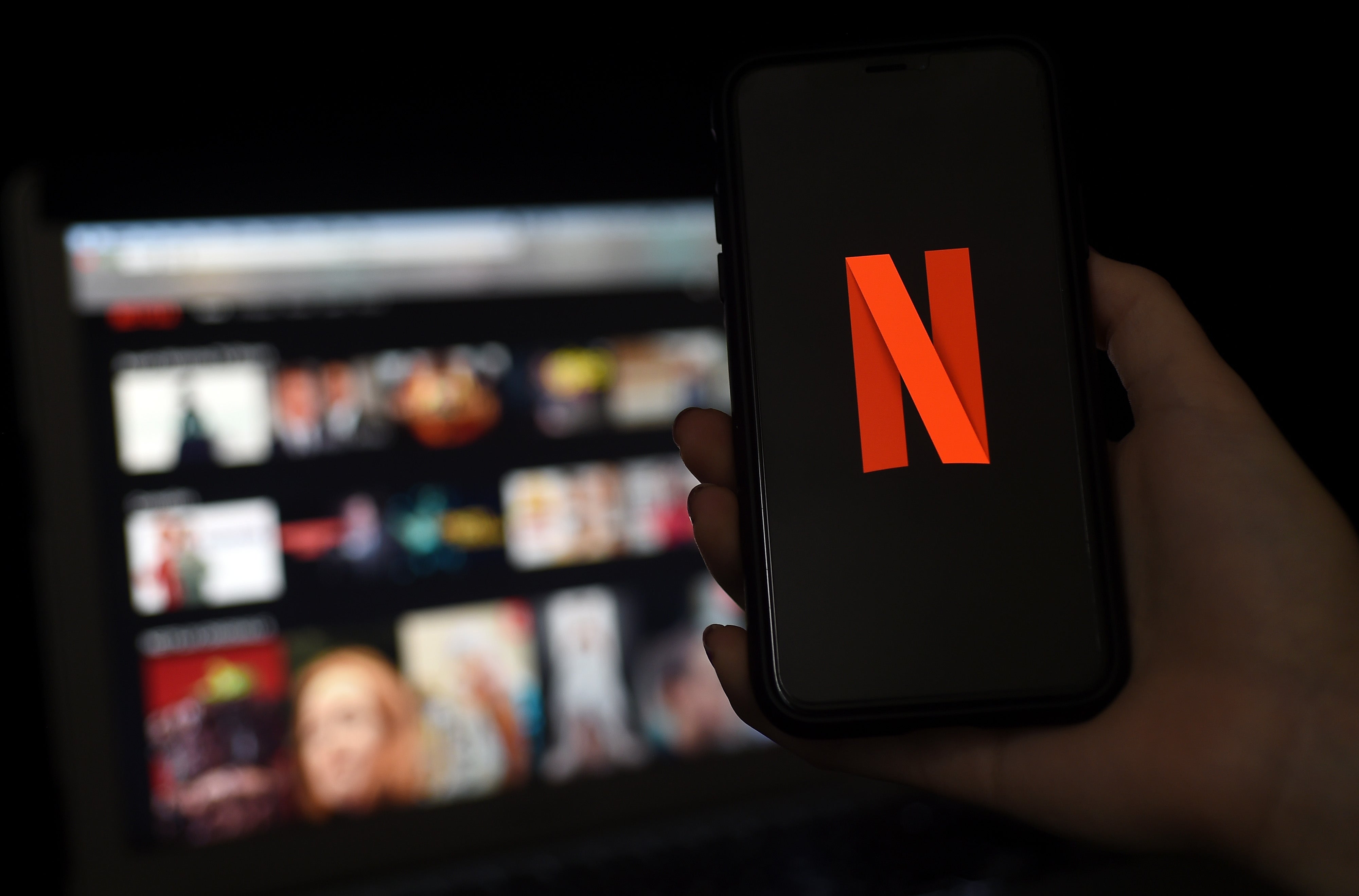 FILE: A computer and a mobile phone screen display the Netflix logo on 31 March 2020 in Arlington, Virginia