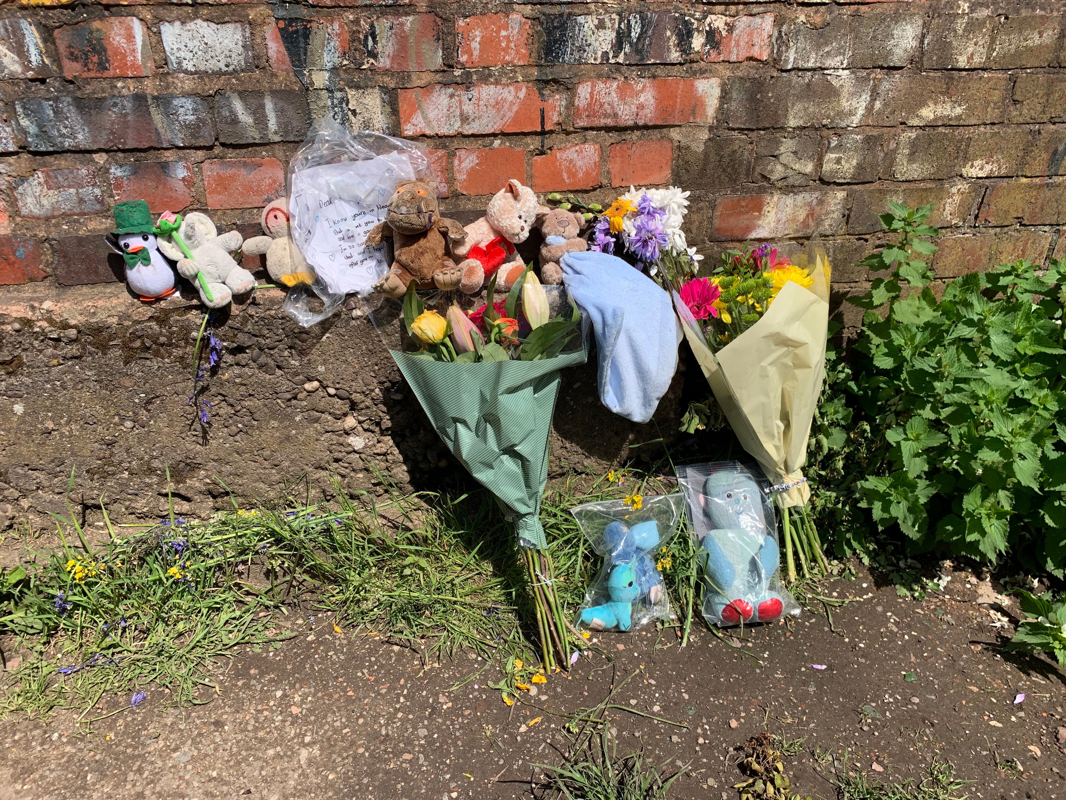 Floral tributes for the baby left near Rough Wood country park