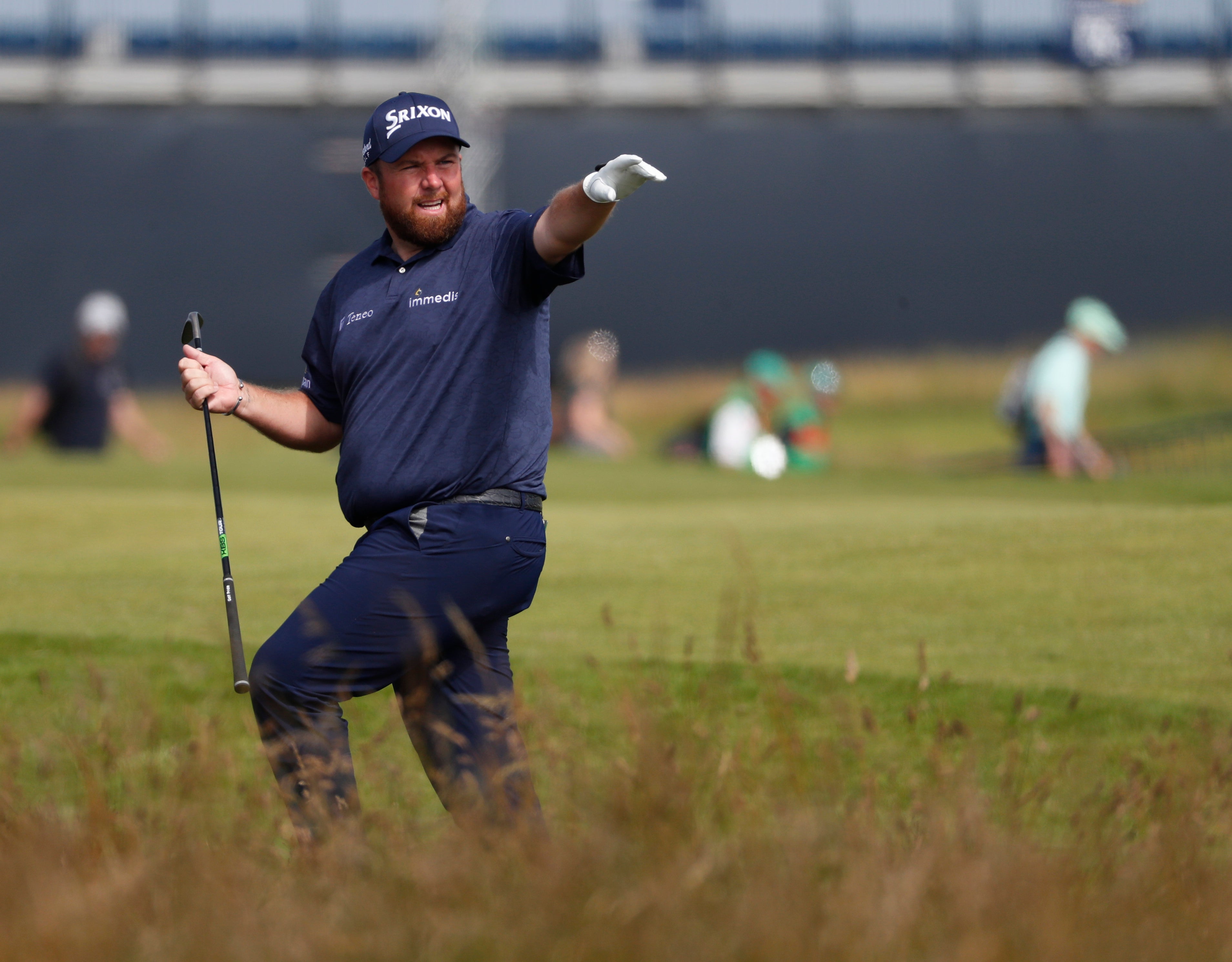 Shane Lowry gestures after playing out of the rough