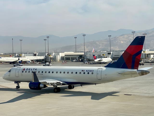 <p>In this file photo a Delta Airlines plane is seen at the gate at Salt Lake City International Airport (SLC), Utah, on 5 October 2020</p>