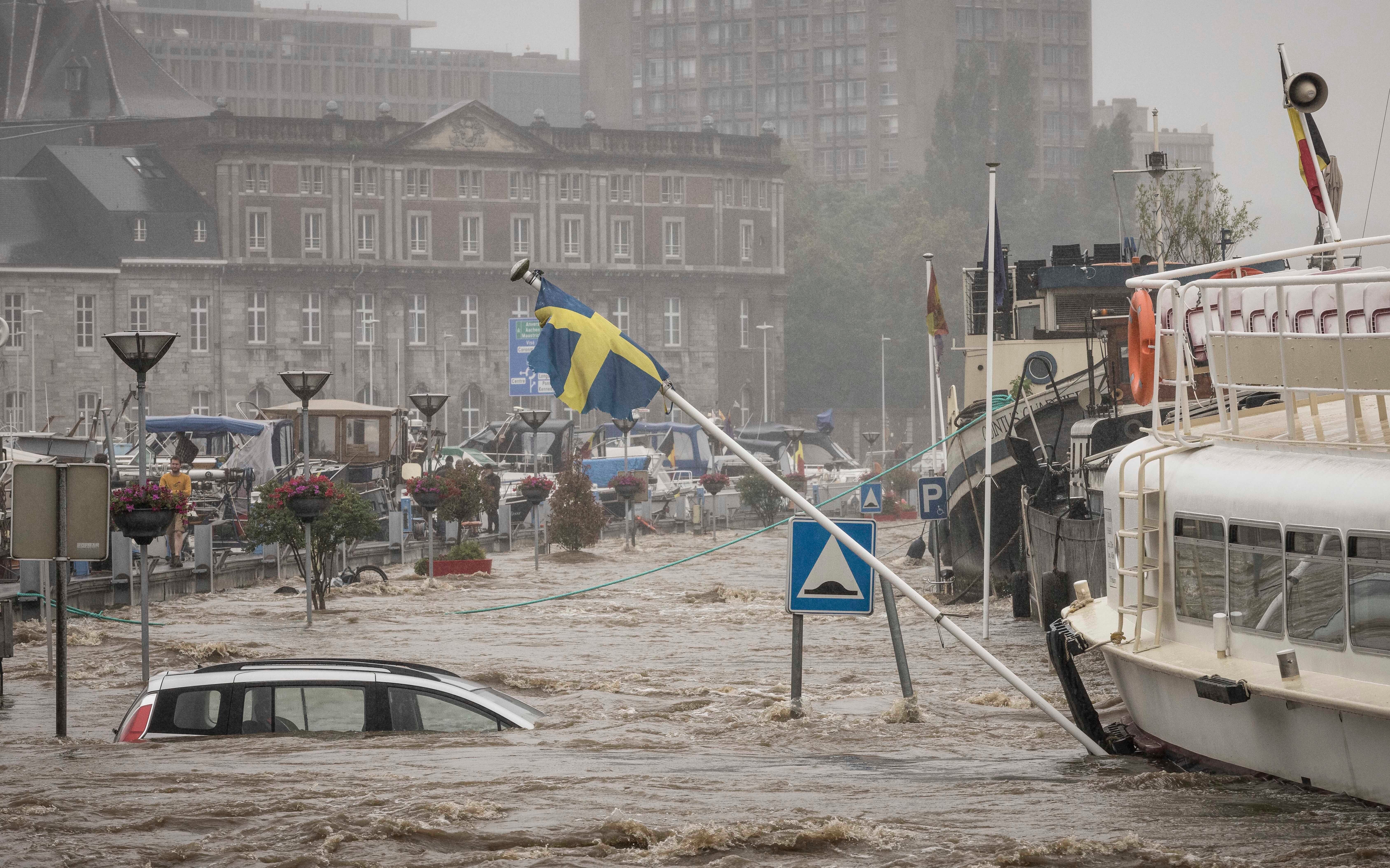 A car floats in the Meuse River in Liege