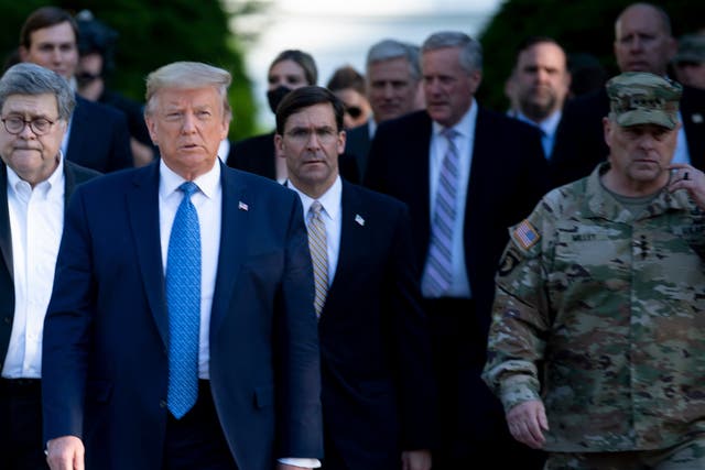 <p>Donald Trump walks with Chairman of the Joint Chiefs of Staff Mark Milley and others to visit St John’s Church on June 1, 2020, in Washington, DC.</p>