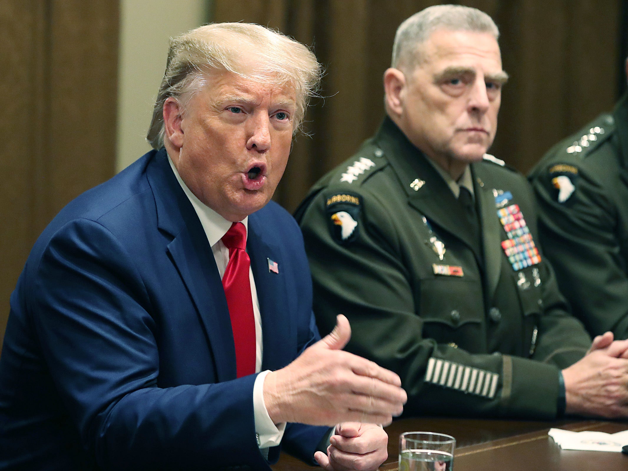 U.S. President Donald Trump speaks as Joint Chiefs of Staff Chairman, Army General Mark Milley looks on after a briefing from senior military leaders in the Cabinet Room at the White House on October 7, 2019 in Washington, DC.