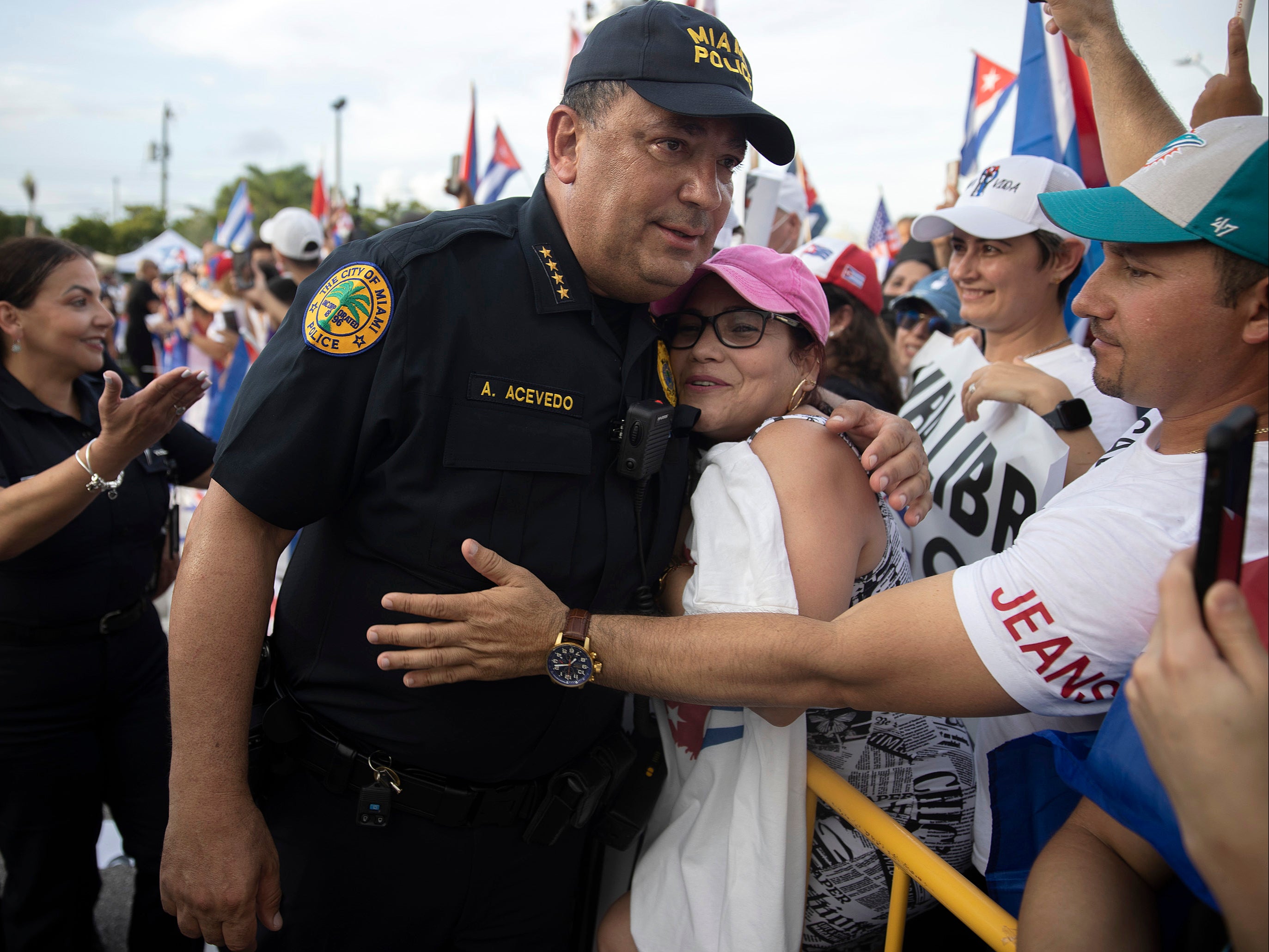 Miami Police Chief Art Acevedo hugs a protester after some had become agitated as music was being played in front of the Versailles restaurant on 14 July 2021 in Miami, Florida.