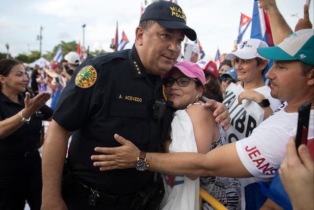 <p>Miami Police Chief Art Acevedo hugs a protester after some had become agitated as music was being played in front of the Versailles restaurant on 14 July 2021 in Miami, Florida. </p>