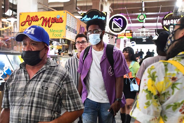 <p>Masked and unmasked people make their way through Grand Central Market in Los Angeles, California on June 29, 2021 as World Health Organization (WHO) urges fully vaccinated people to continue wearing masks with the rapid spread of the Delta variant. - Officials are issuing new mask guidance as Covid-19 cases are spiking in parts of the US, especially in areas with low vaccination rates due to the more contagious Delta variant.</p>