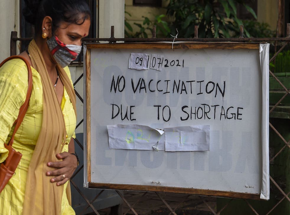 <p>A woman walks past a vaccination centre that was shut due to shortage of doses in India’s Mumbai city on 9 July, 2021</p>