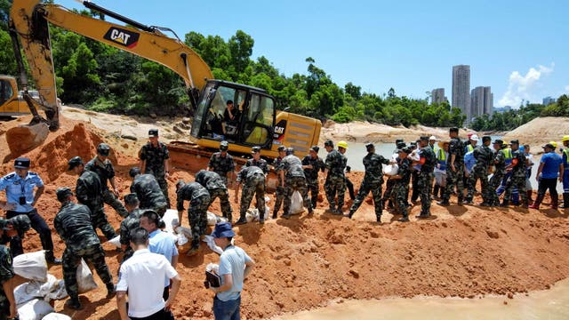 <p>Paramilitary police officers work on trying to rescue 14 workers trapped in Zhuhai, in China's southern Guangdong province</p>