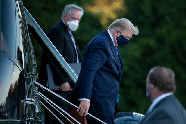 <p>White House Chief of Staff Mark Meadows (L) watches as the then-US President Donald Trump (C) walks off Marine One while arriving at Walter Reed Medical Center in Bethesda, Maryland on 2 October  2020</p>