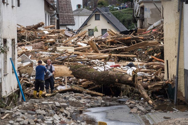 <p>Two men move debris after homes were destroyed in Schuld, Germany. </p>