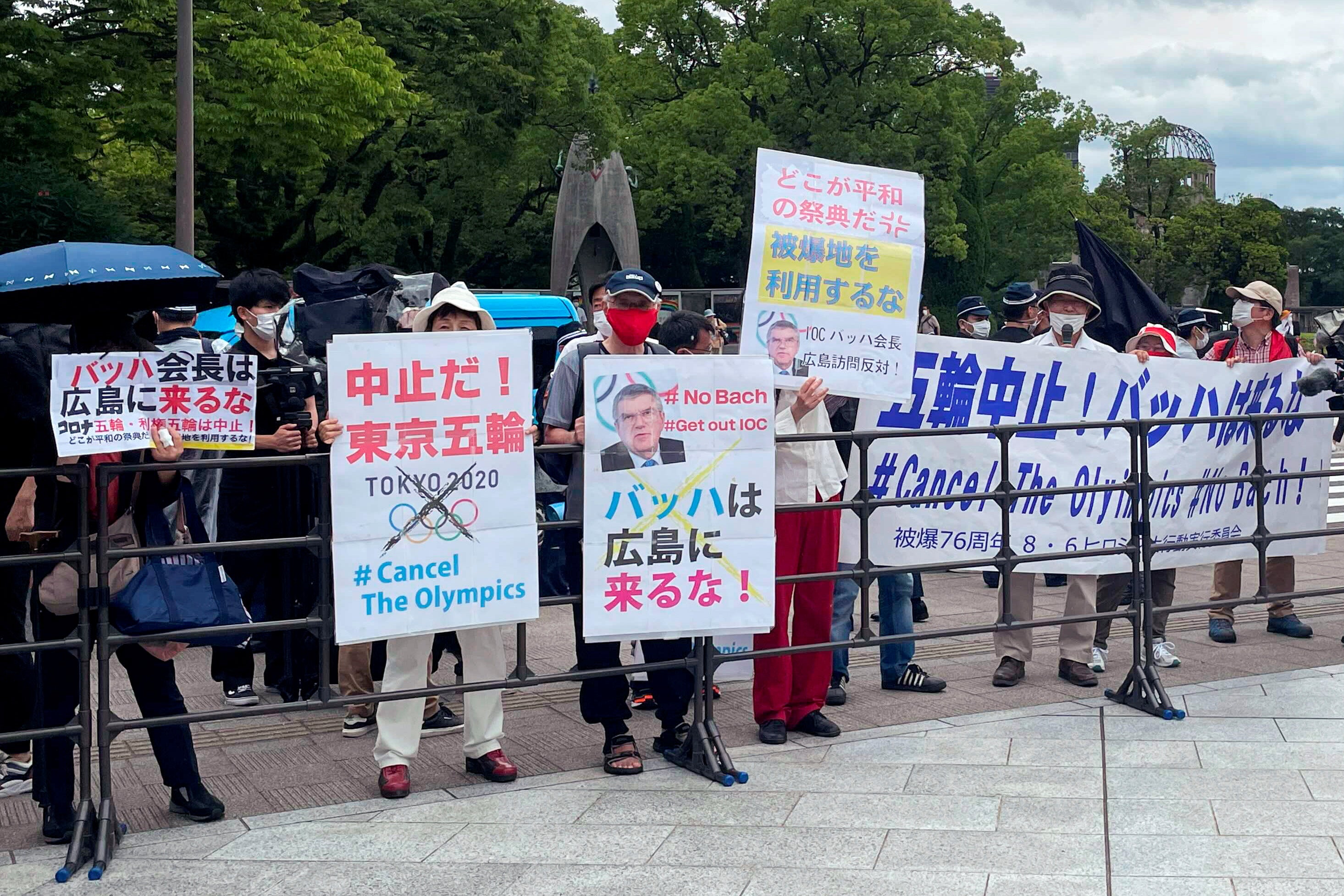 Protesters gather before International Olympic Committee President Thomas Bach's visit Hiroshima Memorial Cenotaph in Hiroshima