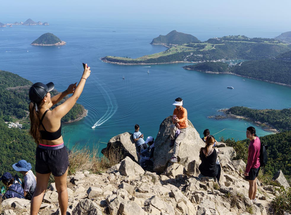 <p>Representative: In this 29 February 2020 photo, hikers take pictures on High Junk Peak overlooking Clearwater Bay in the Tsuen Kwan O area of Hong Kong</p>