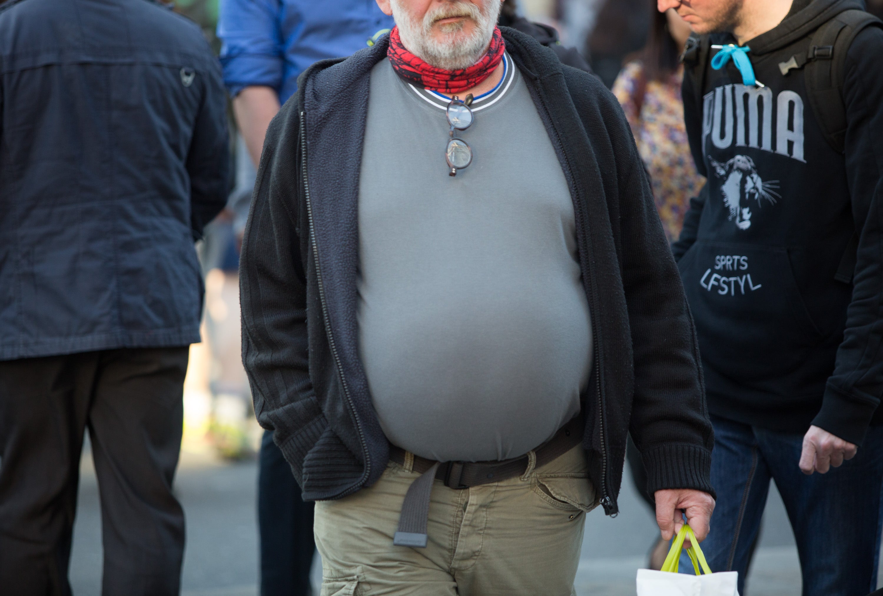Overweight man walks down street