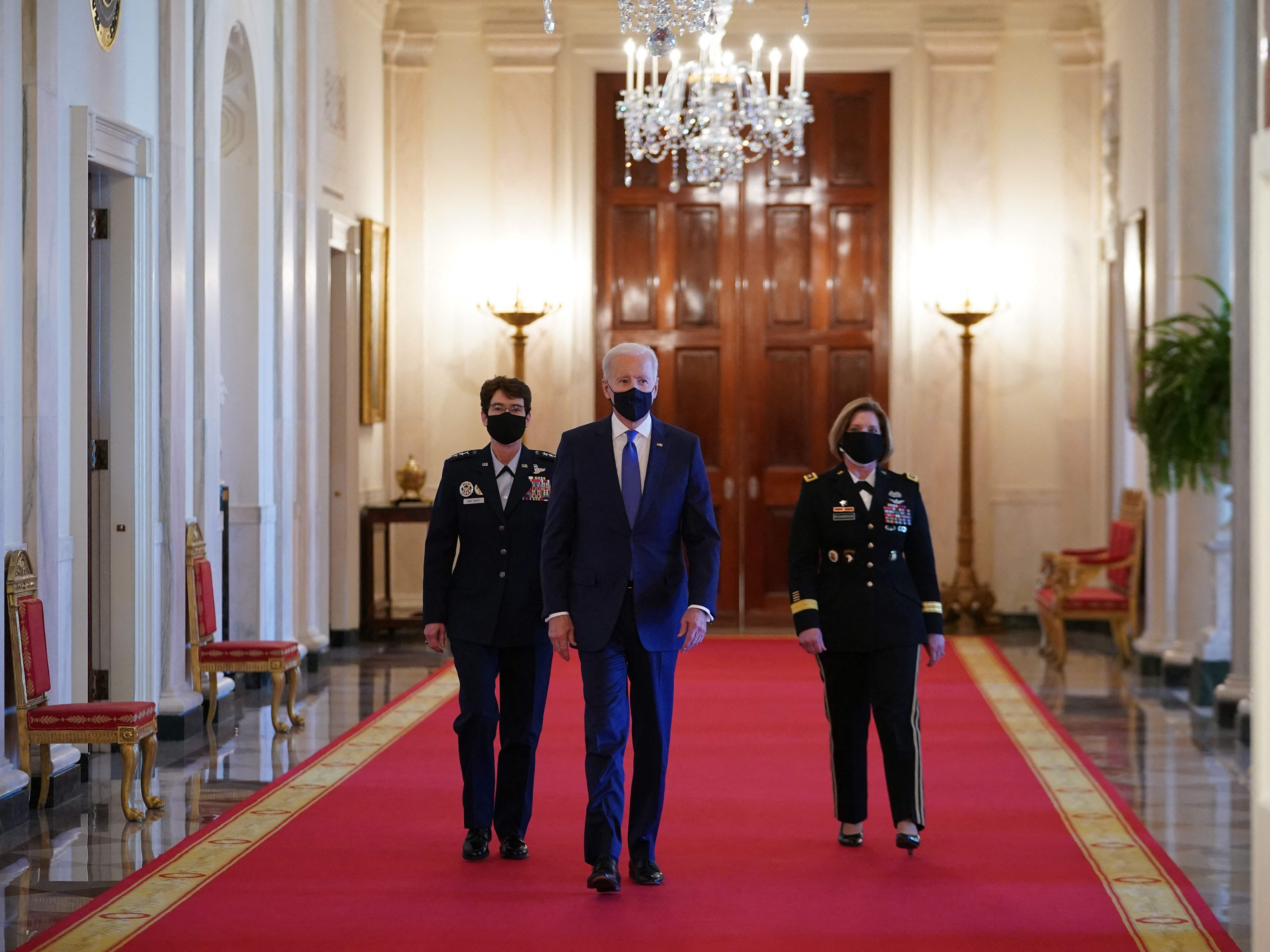 President Joe Biden is flanked by the nominees to positions as 4-star Combatant Commanders, General Jacqueline Van Ovost and Lieutenant General Laura Richardson, on March 8, 2021.